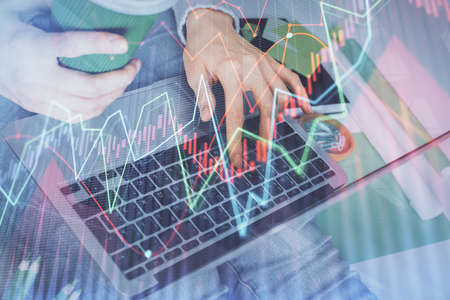 Double exposure of woman hands typing on computer and forex chart hologram drawing. Stock market...