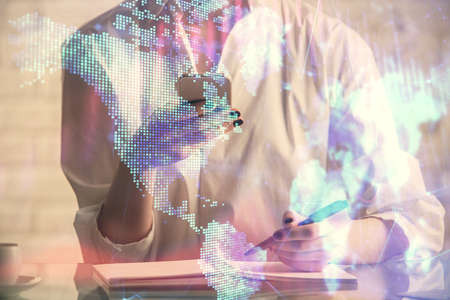 Double exposure of financial graph sketch hologram and woman holding and using a mobile device. Stock exchange concept.の写真素材