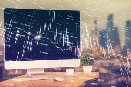 Forex market graph hologram and personal computer on background. Double exposure. Concept of...