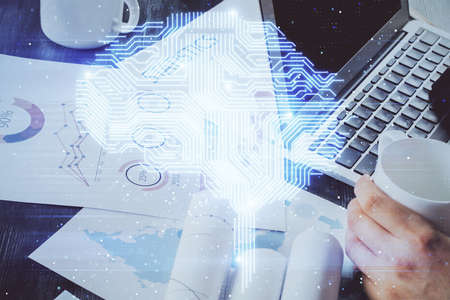 Businessman with computer background with brain theme hologram. Concept of brainstorm. Multi...