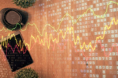 Multi exposure of financial chart hologram over desktop with phone. Top view. Mobile trade platform...