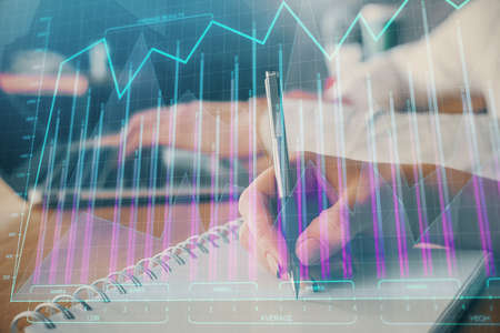 Double exposure of forex chart drawing over people taking notes background. Concept of financial...