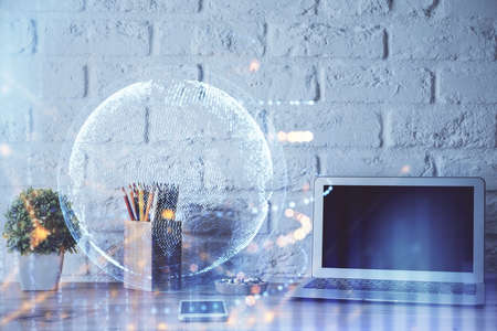 Double exposure of desktop with computer and world map hologram. International data network concept.の写真素材