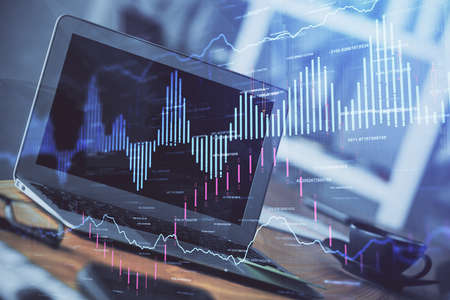 Forex market graph hologram and personal computer on background. Multi exposure. Concept of...