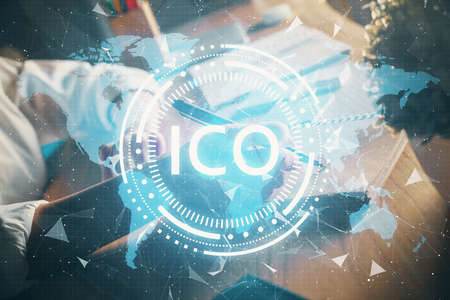 Cryptocurrency hologram, bitcoin, ico theme over hands taking notes background. Concept of...