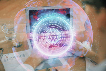 Technology theme hologram with man working on computer on background. High tech concept. Double...