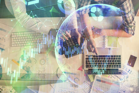 Double exposure of man and woman working together and financial graph hologram drawing. market...