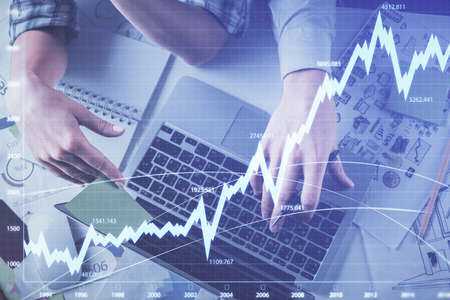 Double exposure of man and woman working together and forex graph hologram drawing. Financial...