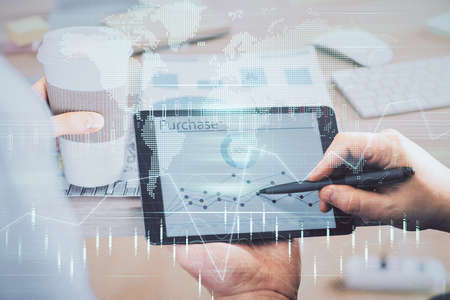 Double exposure of mans hands holding and using a phone and financial chart drawing. Market analysis...