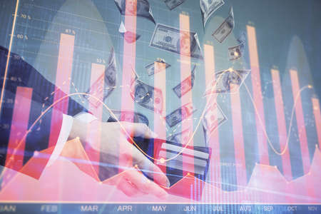 Multi exposure of financial graph drawing hologram and USA dollars bills and man hands. Analysis concept.の写真素材