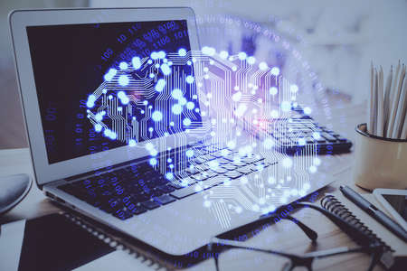 Double exposure of desktop with computer and brain drawing hologram. Artificial intelligence...