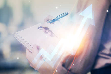 Blue arrow over womans hands taking notes background. Concept of success. Double exposure