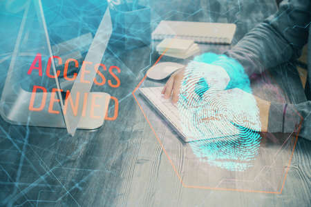 Fingerprint hologram with businessman working on computer on background. Security concept. Double exposure.の写真素材