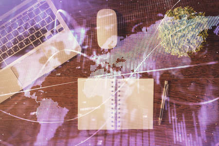 Stock market graph and top view computer on the table background. Double exposure. Concept of...