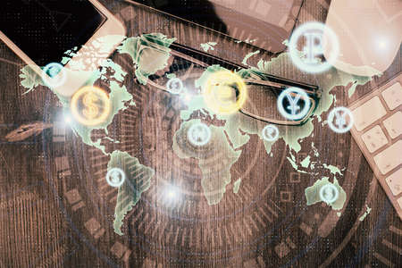 Multi exposure of forex graph hologram over desktop with phone. Top view. Mobile trade platform...