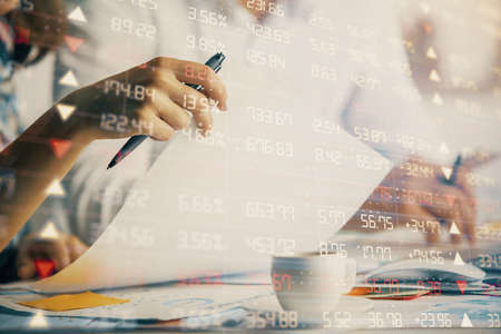 Double exposure of forex graph drawing over people taking notes background. Concept of financial...