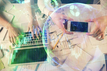 Multi exposure of man and woman working together and forex graph hologram drawing. Financial...