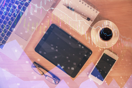 Multi exposure of forex graph hologram over desktop with phone. Top view. Mobile trade platform concept.の写真素材