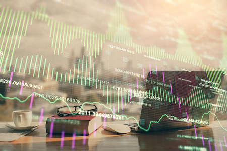 Double exposure of financial chart drawings and desk with open notebook background. Concept of forex...