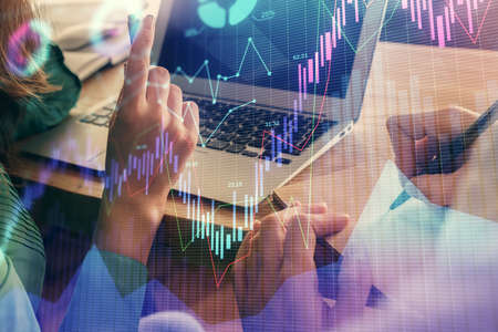 Double exposure of man and woman working together and forex chart hologram. Business concept....