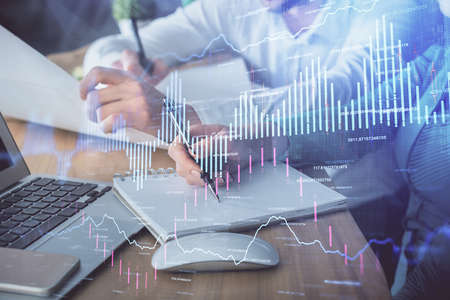 Double exposure of forex chart drawing over people taking notes background. Concept of financial...