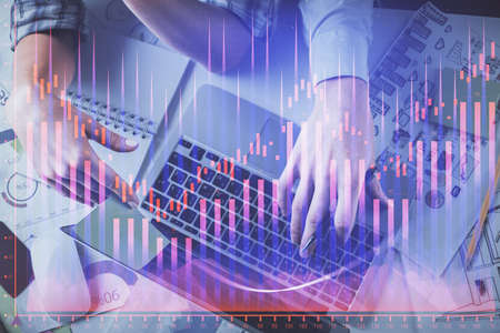 Double exposure of man and woman working together and forex graph hologram drawing. Financial...