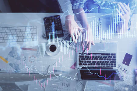 Double exposure of man and woman working together and financial graph hologram drawing. market...