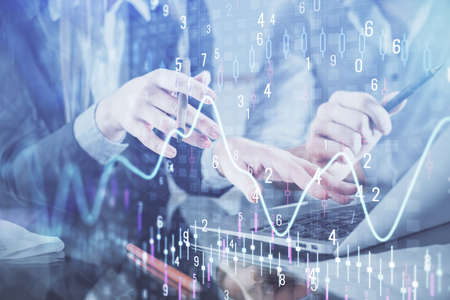 Multi exposure of man and woman working together and financial chart hologram. Business concept....