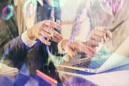 Double exposure of man and woman working together and forex chart hologram. Business concept....