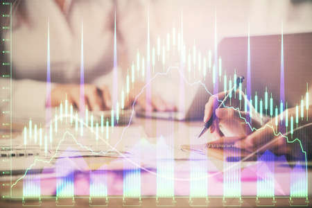 Multi exposure of woman hands typing on computer and forex chart hologram drawing. Stock market...