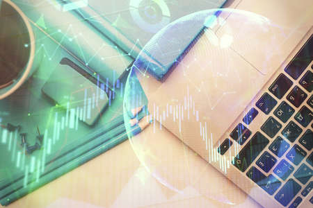 Double exposure of forex graph drawing over desktop background with computer. Concept of financial...