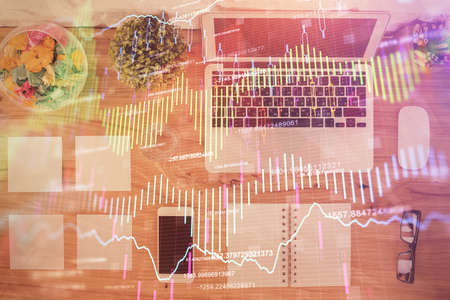 Stock market graph and top view computer on the table background. Multi exposure. Concept of...
