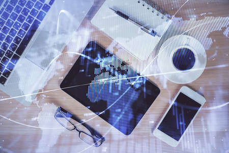 Multi exposure of forex graph hologram over desktop with phone. Top view. Mobile trade platform...