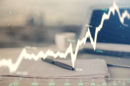 Double exposure of financial graph drawings and desk with open notebook background. Concept of forex...