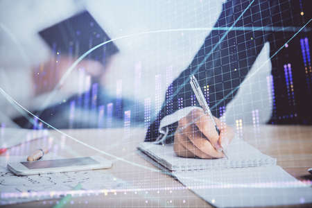 Double exposure of forex chart drawing over people taking notes background. Concept of financial...