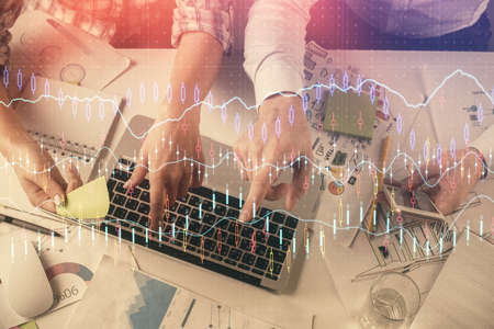 Multi exposure of man and woman working together and forex graph hologram drawing. Financial...