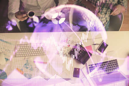 Double exposure of man and woman working together and financial chart hologram drawing. market...