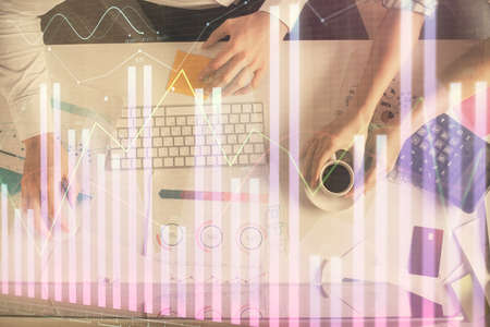 Double exposure of man and woman working together and financial chart hologram drawing. market...