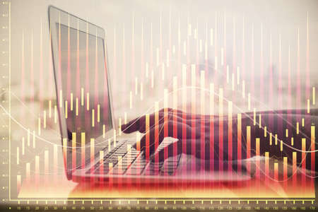 Double exposure of woman hands typing on computer and forex chart hologram drawing. Stock market...