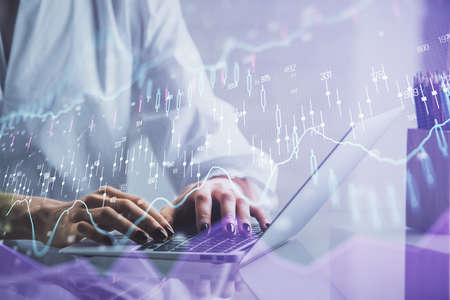 Double exposure of woman hands typing on computer and forex chart hologram drawing. Stock market...
