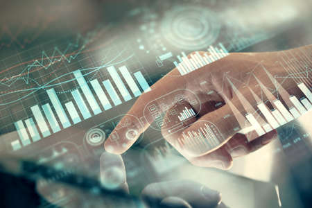Multi exposure of mans hands holding and using a phone and financial chart drawing. Market analysis...