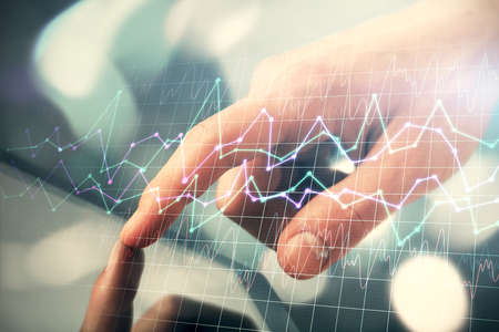 Multi exposure of mans hands holding and using a phone and financial chart drawing. Market analysis...