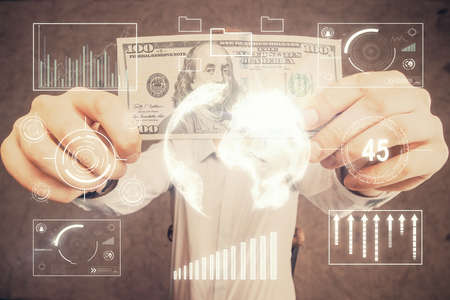 Multi exposure of forex graph drawing hologram and USA dollars bills and man hands. Technical...