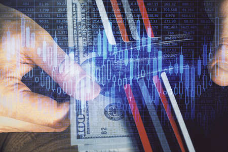 Multi exposure of forex graph drawing hologram and USA dollars bills and man hands. Technical...