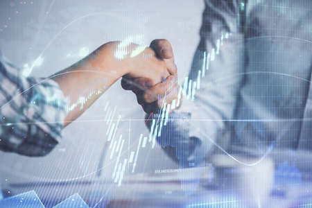 Double exposure of forex graph hologram and handshake of two men. Stock market concept.