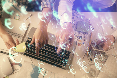 Multi exposure of man and woman working together and forex graph hologram drawing. Financial analysis concept. Computer background. Top View.の写真素材