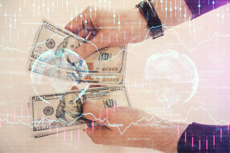 Multi exposure of financial graph drawing hologram and USA dollars bills and man hands. Analysis concept.の写真素材