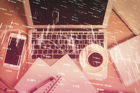 Stock market chart and top view computer on the table background. Double exposure. Concept of financial analysis.の写真素材