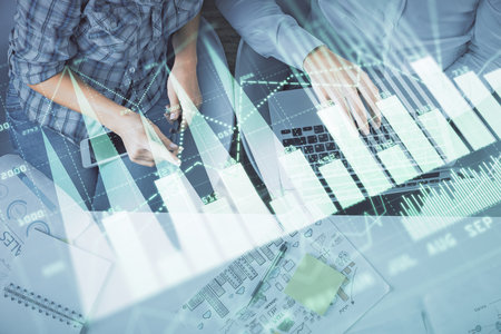Multi exposure of man and woman working together and forex graph hologram drawing. Financial analysis concept. Computer background. Top View.の写真素材
