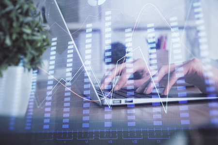Double exposure of woman hands typing on computer and forex chart hologram drawing. Stock market invest concept.の写真素材